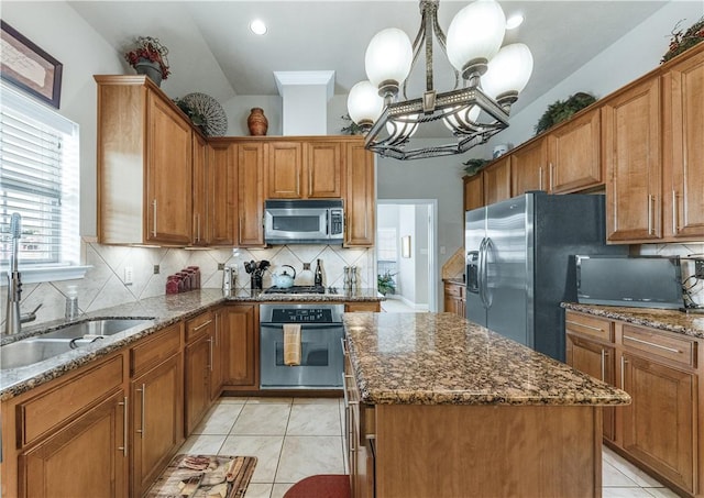 kitchen featuring pendant lighting, sink, appliances with stainless steel finishes, a kitchen island, and light tile patterned flooring