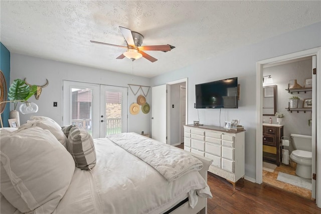 bedroom with access to outside, a textured ceiling, dark wood-style floors, and french doors