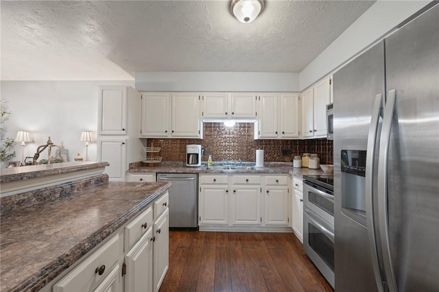 kitchen with white cabinetry, a textured ceiling, and appliances with stainless steel finishes