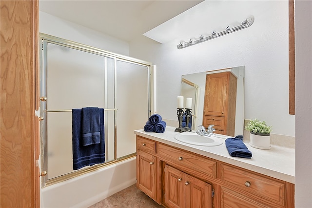 bathroom with bath / shower combo with glass door and vanity