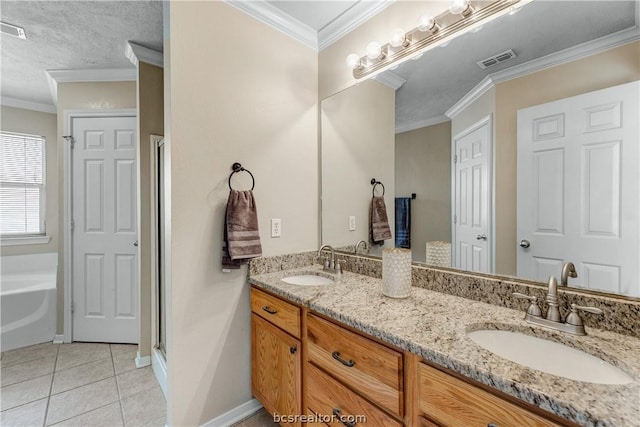 bathroom with tile patterned floors, a tub, vanity, and ornamental molding