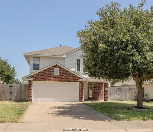 view of front of home featuring a front yard and a garage