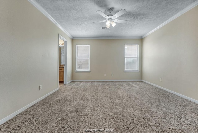 carpeted spare room with ceiling fan, a textured ceiling, and ornamental molding