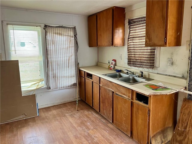 808 W Boundary St, Giddings, TX 78942 - kitchen with sink and light hardwood / wood-style flooring