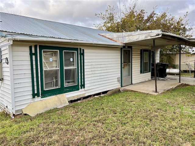 rear view of house featuring a yard and a patio