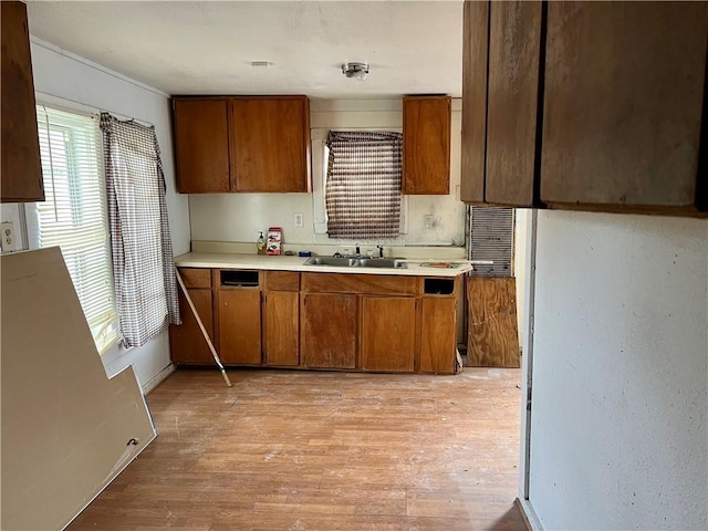 808 W Boundary St, Giddings, TX 78942 - kitchen featuring light hardwood / wood-style flooring and sink