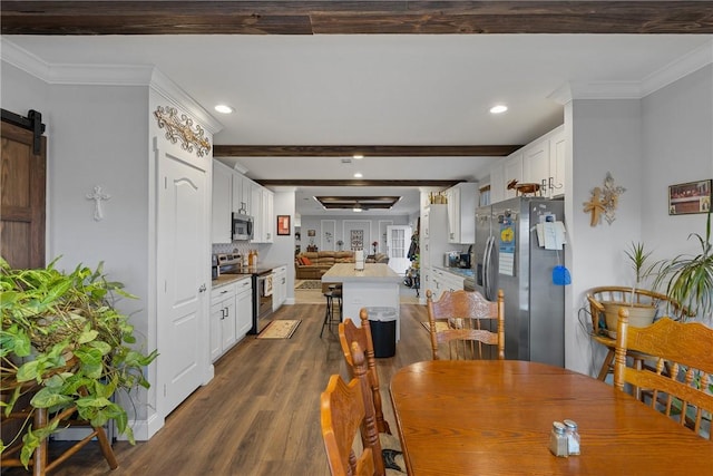 dining space with a barn door, recessed lighting, dark wood-type flooring, beamed ceiling, and crown molding