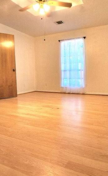 1706 Shawnee St, Navasota, TX 77868 - empty room with light wood-type flooring and a ceiling fan