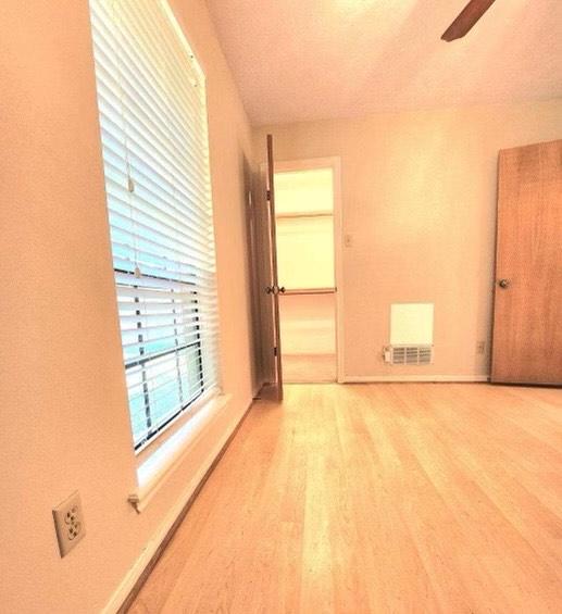 1706 Shawnee St, Navasota, TX 77868 - empty room featuring wood finished floors, ceiling fan, and baseboards