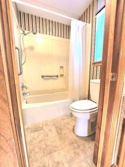 1706 Shawnee St, Navasota, TX 77868 - bathroom with toilet and shower / bath combo