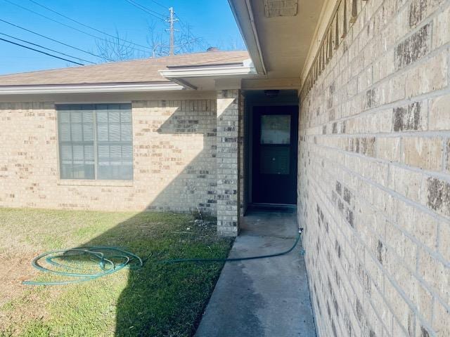 entrance to property with brick siding