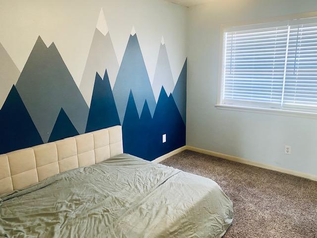 carpeted bedroom with baseboards