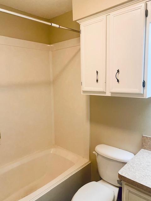 full bath with shower / bathing tub combination, vanity, and toilet