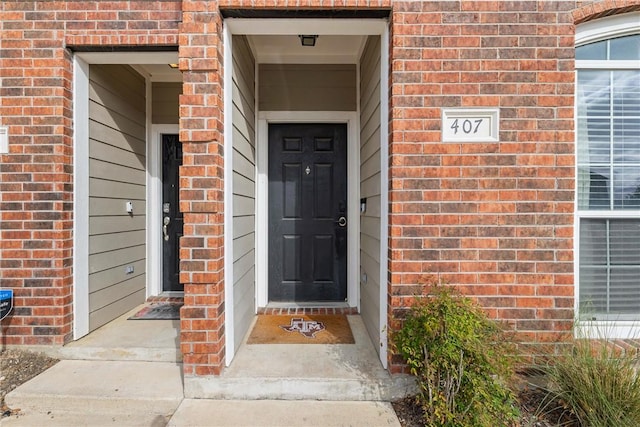 entrance to property with brick siding
