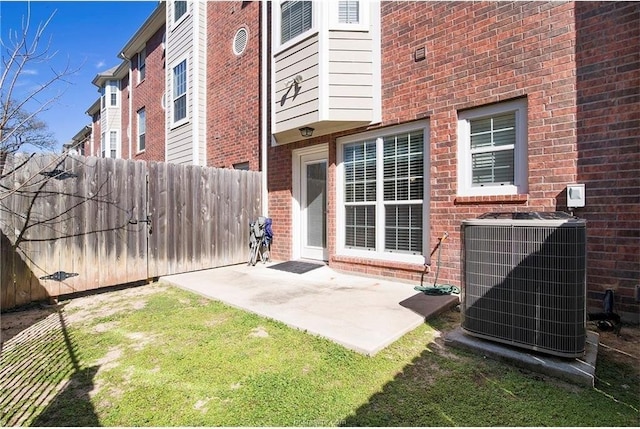 view of exterior entry with cooling unit and a patio