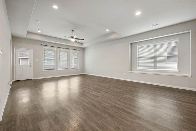 4706 Coyotillo Way, Bryan, TX 77807 - unfurnished living room featuring a raised ceiling, ceiling fan, dark wood-style flooring, and recessed lighting