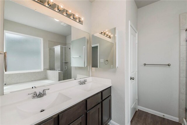 4706 Coyotillo Way, Bryan, TX 77807 - bathroom with a stall shower, double vanity, wood finished floors, and a garden tub