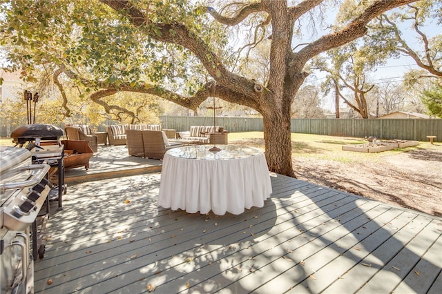 deck with outdoor lounge area and a fenced backyard