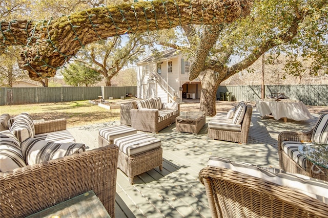 view of patio / terrace featuring stairway, an outdoor hangout area, a fenced backyard, and a deck