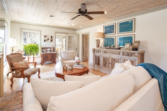 living area with visible vents, light wood-style flooring, wood ceiling, and a ceiling fan