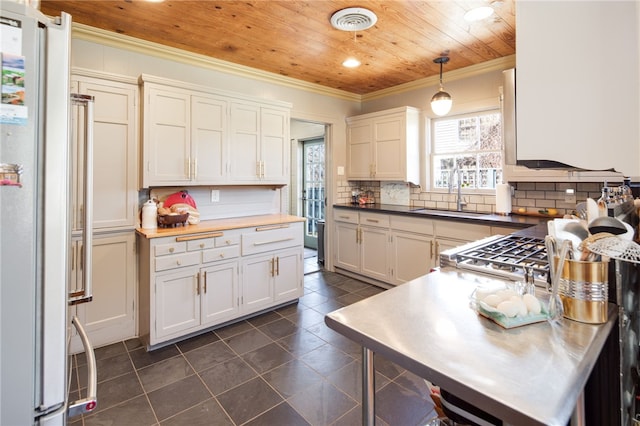 kitchen featuring ornamental molding, decorative backsplash, wooden ceiling, high end fridge, and a sink