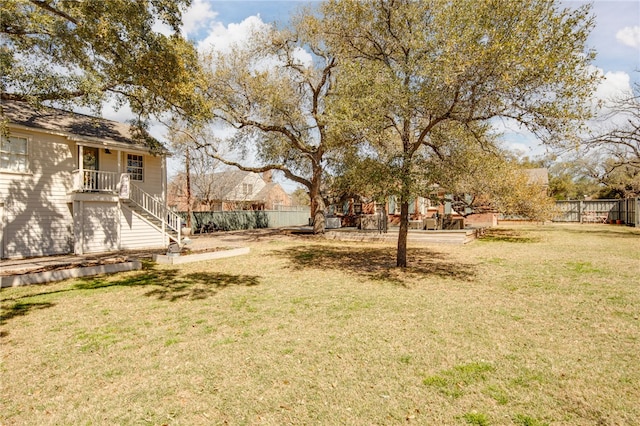 view of yard featuring stairway and fence