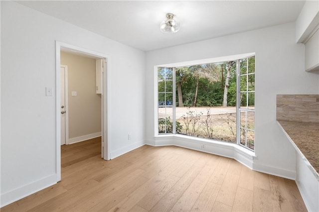 unfurnished dining area with light hardwood / wood-style flooring