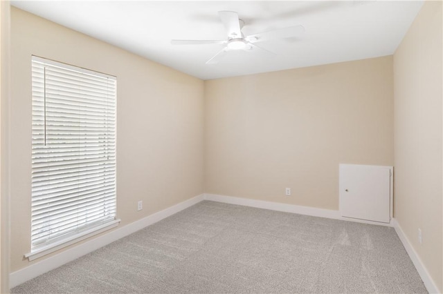 empty room with light colored carpet, plenty of natural light, and ceiling fan