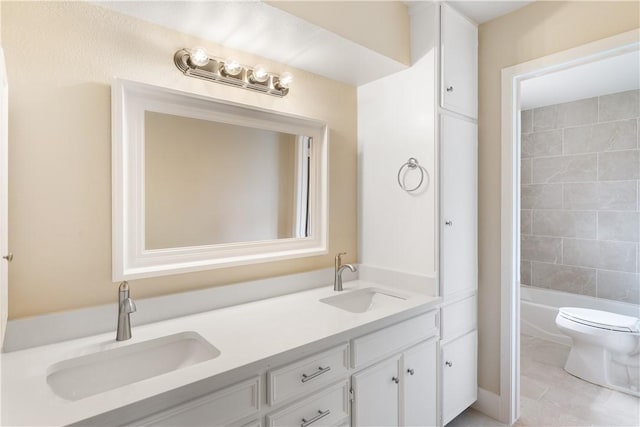 full bathroom featuring tiled shower / bath, tile patterned flooring, vanity, and toilet