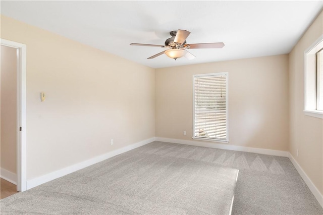 carpeted empty room featuring ceiling fan