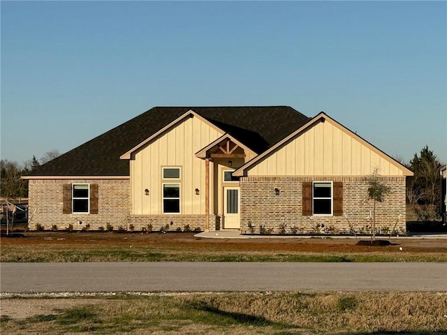 view of front of property featuring brick siding and board and batten siding