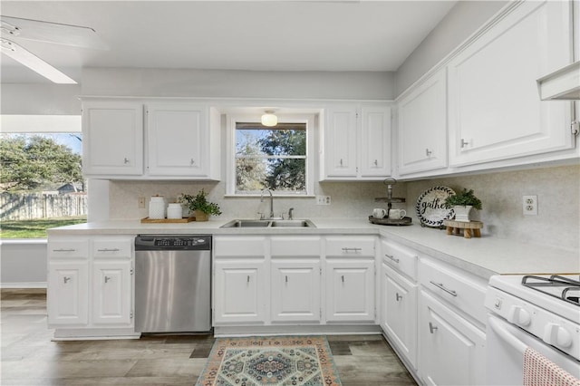 kitchen with ceiling fan, sink, stainless steel dishwasher, white range oven, and white cabinets