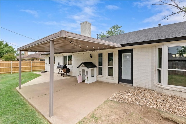 view of patio featuring fence and area for grilling