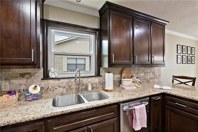 kitchen featuring dark brown cabinetry, stainless steel dishwasher, and a sink