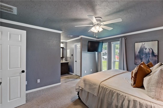 bedroom with crown molding, light carpet, baseboards, ensuite bath, and visible vents