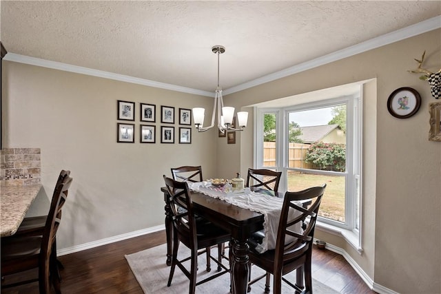 dining space with dark wood-type flooring, a chandelier, crown molding, and baseboards