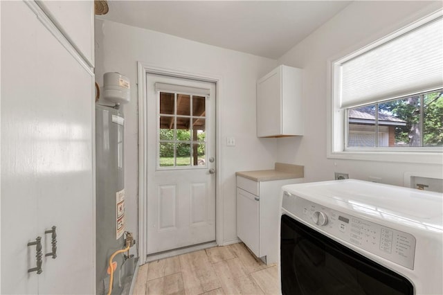1502 Glade St, College Station, TX 77840 - washroom with washer / dryer, cabinet space, gas water heater, and plenty of natural light