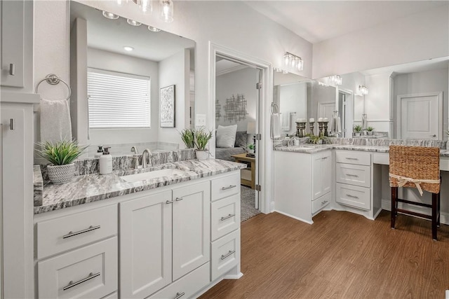 9868 Albert Dr, Iola, TX 77861 - bathroom featuring wood finished floors and two vanities