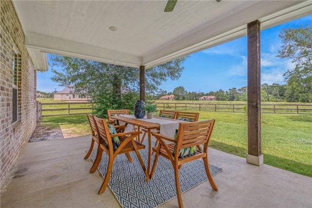 9868 Albert Dr, Iola, TX 77861 - fenced backyard featuring outdoor dining space, a patio, and a rural view