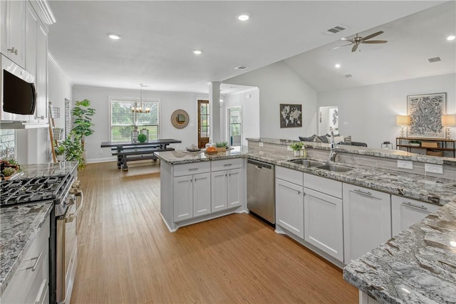 9868 Albert Dr, Iola, TX 77861 - kitchen with appliances with stainless steel finishes, light wood finished floors, ceiling fan, white cabinets, and light stone countertops