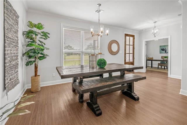 9868 Albert Dr, Iola, TX 77861 - dining room with a chandelier, plenty of natural light, light wood-style flooring, and ornamental molding