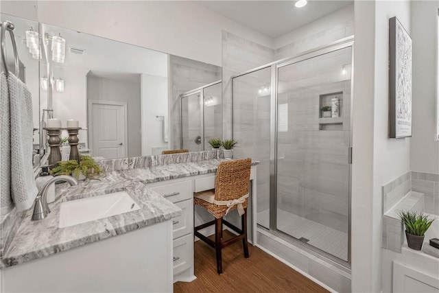 9868 Albert Dr, Iola, TX 77861 - full bath featuring vanity, a stall shower, wood finished floors, and recessed lighting