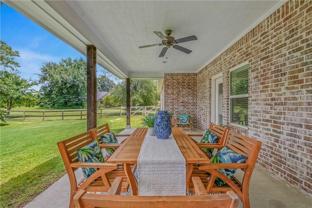 9868 Albert Dr, Iola, TX 77861 - fenced backyard featuring outdoor dining area, ceiling fan, and a patio area