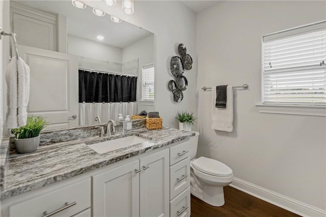 9868 Albert Dr, Iola, TX 77861 - full bathroom with vanity, wood finished floors, and a shower with shower curtain