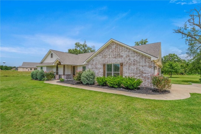 9868 Albert Dr, Iola, TX 77861 - ranch-style house with a front lawn, brick siding, board and batten siding, a shingled roof, and concrete driveway