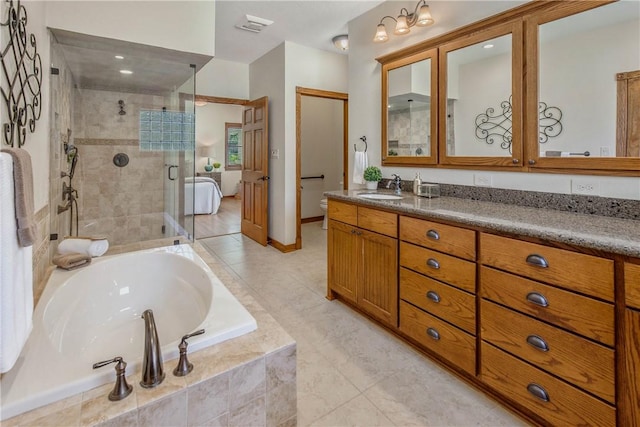 full bathroom featuring vanity, independent shower and bath, and toilet