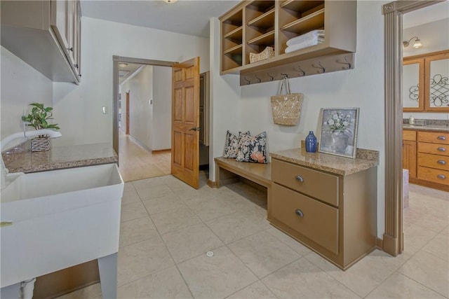 mudroom featuring light tile patterned flooring and sink