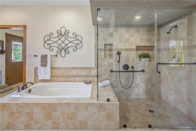 bathroom featuring separate shower and tub