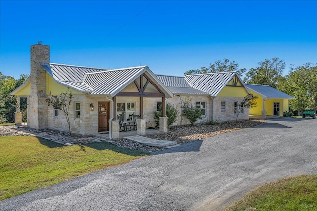 modern farmhouse featuring a front lawn and a porch