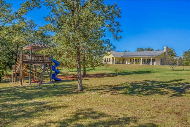 view of yard featuring a gazebo and a playground